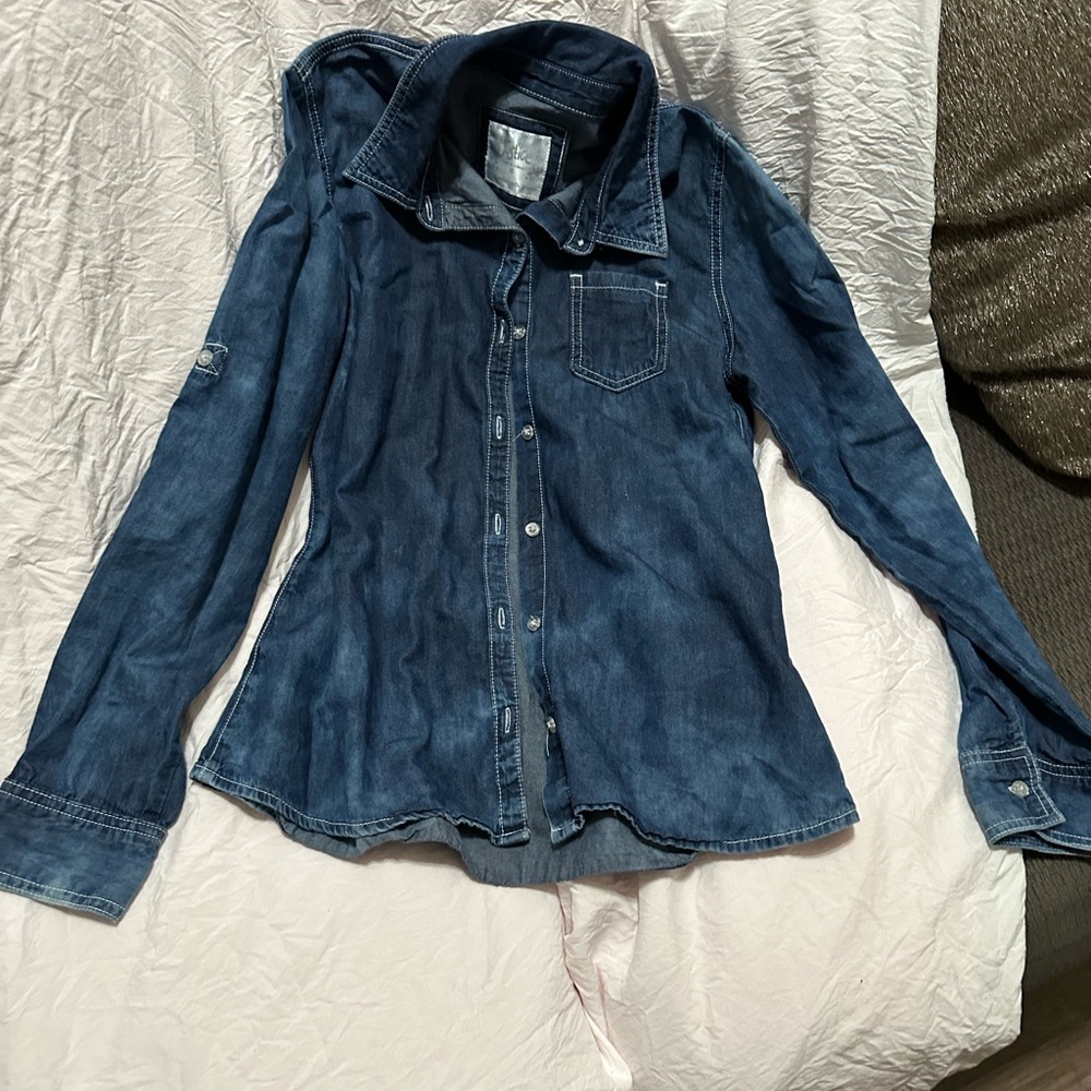 Justice dark blue flannel with white glitter buttons in the front.